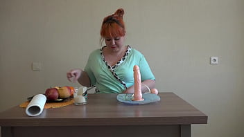 Redhead chubby milf imitates a blowjob, fucks her asshole, shakes her gorgeous buttocks, simulates sperm from a dildo on her pretty face.
